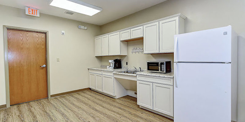 Small kitchenette with fridge, microwave, and coffee maker.