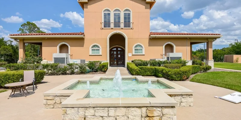 Exterior of a two-story rehab facility with a red tile roof.